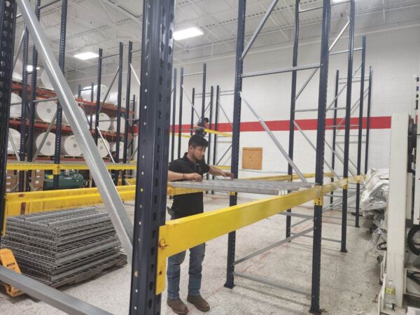 Warehouse storage pallet rack shelving installation in Greensboro, NC. This install included new Mecalux teardrop style uprights, used teardrop style beams and wire mesh decking.