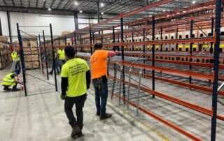 man helping with pallet rack maintenance